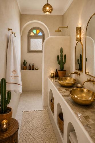 a bathroom with two sinks and a cactus at Riad Sesame in Marrakesh