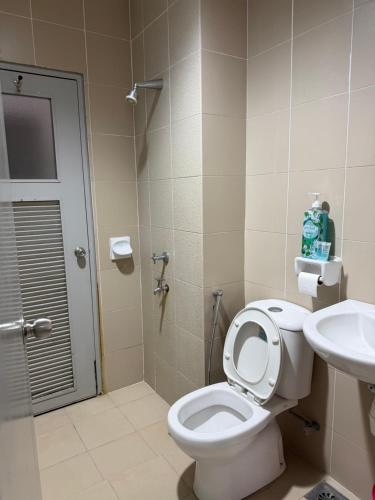 a bathroom with a toilet and a sink at Singgah homestay saujana aster in Putrajaya