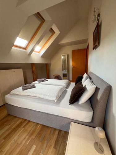 a bedroom with a large bed with white sheets and pillows at U Izhu with Private Pool, Sauna & BBQ in Prevala
