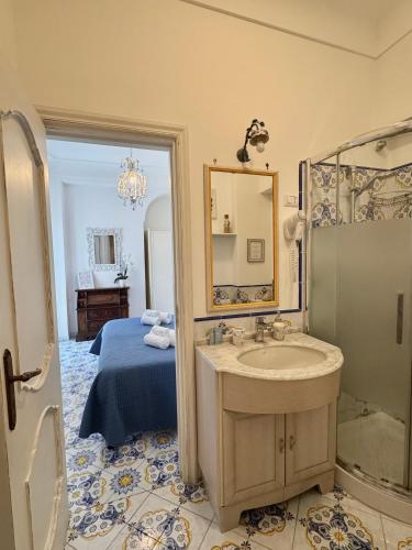 a bathroom with a sink and a shower and a bed at B&B Villa Cristina in Anacapri