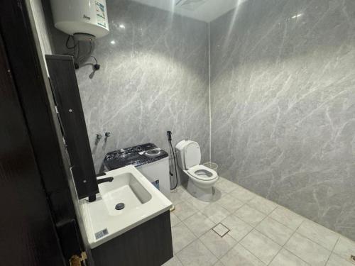 a bathroom with a sink and a toilet at ارام للشقق المخدومة in Taif