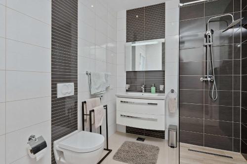 a bathroom with a toilet and a sink and a shower at House Green in Vrh