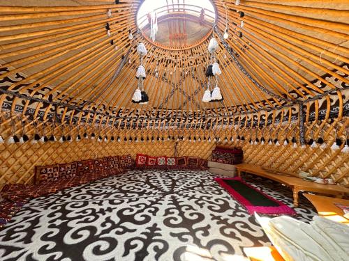 a large room with a large ceiling in a yurt at Yurt guesthouse in Osh