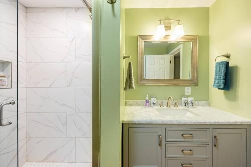 a bathroom with a shower and a sink and a mirror at Shenandoah Thunder Chalet Guest Suite in Front Royal