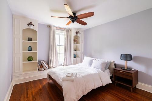 a bedroom with a bed with a ceiling fan at Modern & Spacious 1908 Home in Stratford