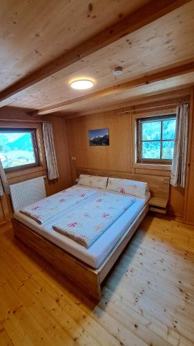 a bedroom with a large bed in a cabin at Ferienhaus Berger in Virgen