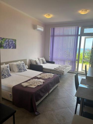 a hotel room with two beds and a window at Villa Maria 2 in Chernomorets