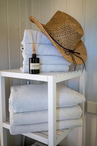 a towel rack with towels and a hat on it at Skandi Design Ferienhaus mit Hafenblick & Beach in Wandlitz