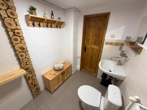 a bathroom with a toilet and a sink at Chalupa Jaseň in Ždiar