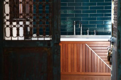 a bathroom with a sink with blue tiles at Old England House in Minas de Ríotinto
