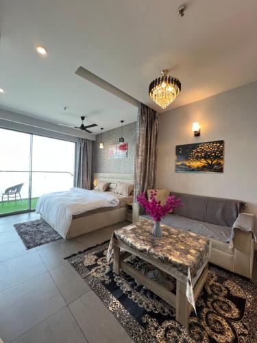 a bedroom with a bed and a couch and a table at Luxurystay-supernova in New Delhi