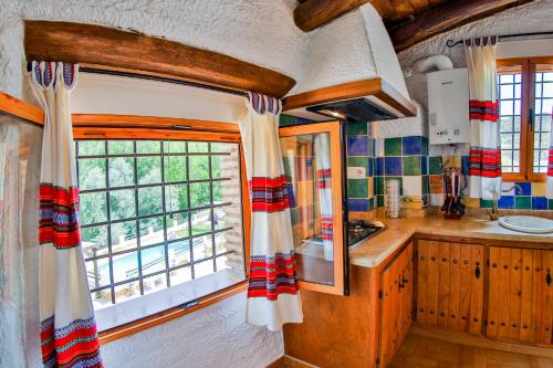 a kitchen with a sink and a window at Cuevas El Moral in Castilléjar