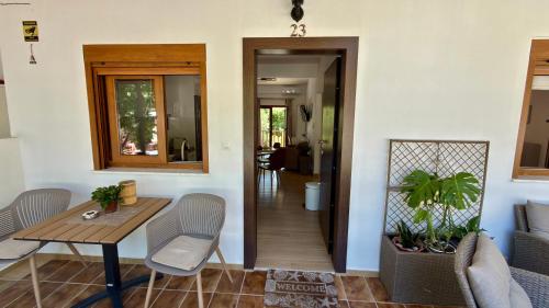 a dining room with a table and chairs and a hallway at Edem Haven Luxury Apartment in Skala Fourkas