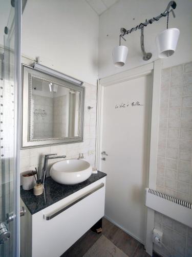a white bathroom with a sink and a mirror at Casa Vacanze Le Cascate in Le Marmore