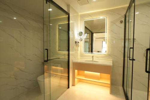 a bathroom with a shower and a sink and a toilet at Bintumani in Freetown