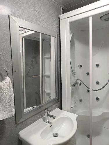 a bathroom with a sink and a shower with a mirror at The Jack Sparrow Hotel in Blackpool