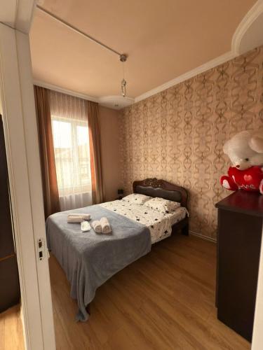 a small bedroom with a bed and a window at Imperia in Akhaltsikhe