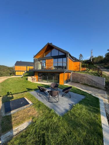 a house on a hill with two chairs in front of it at Vamas Villa in Dobroselica