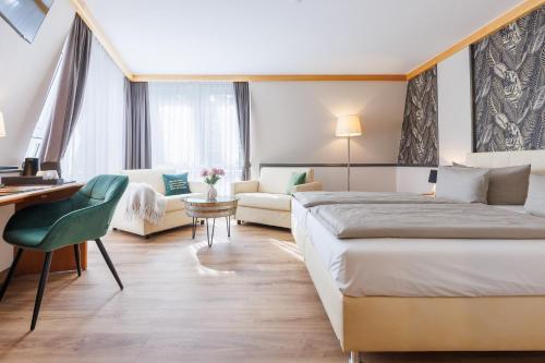 a hotel room with a bed and a desk at Weinberghotel Edelacker in Freyburg