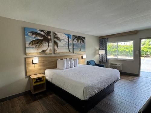 a hotel room with a bed and a window at Days Inn by Wyndham Gainesville Hospital - University Area in Gainesville