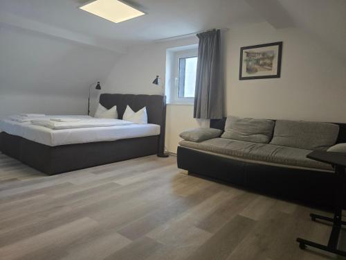 a bedroom with a bed and a couch at Green House in Haibach