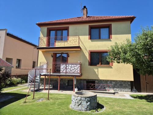 a house with a spiral staircase in front of it at Ubytování Šustovka in Třeboň