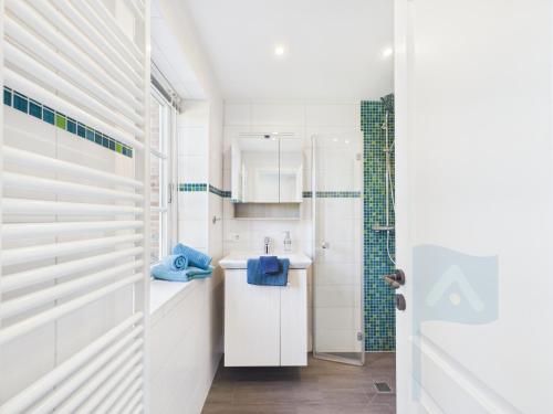 a white bathroom with a sink and a shower at Ferienwohnung Goting in Goting