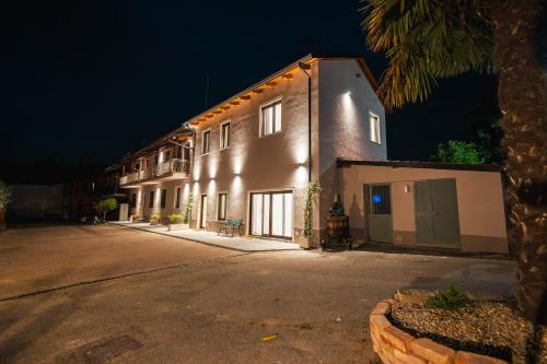a building with lights on the side of it at night at Fermata Sessant in Asti