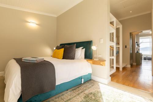 a bedroom with a large bed and a hallway at Lagoon View Cottage in Knysna