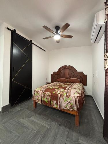 a bedroom with a bed and a ceiling fan at Tiny House Molino Alto in Ciudad Fernández