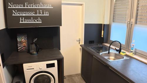 a small kitchen with a sink and a washing machine at Balilounge 1 & Balilounge 2 in Haßloch