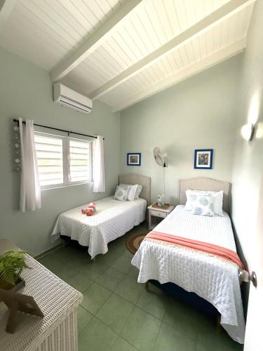 a bedroom with two beds and a window at Lagoon Ocean Resort 2 bdrm/2bath with beach access in Lagun