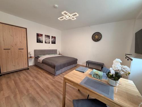 a bedroom with a bed and a desk and a table at Herzstück in Ansbach