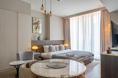 a hotel room with a bed and a table at Luxurious Studio Marina View Condor Marina Star in Dubai