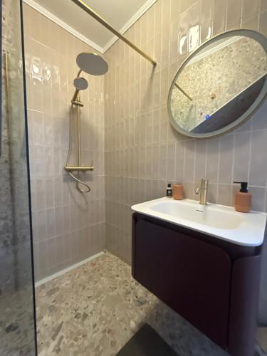 a bathroom with a sink and a mirror at Studio Allure 1 in Kornić