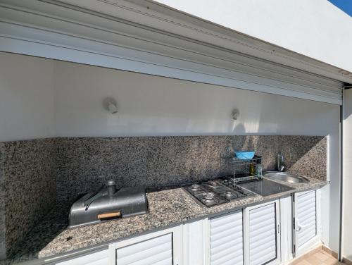 a kitchen with a sink and a counter top at Villa SUN SQUARE DJERBA in Awlād ‘Umar