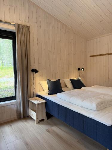 two beds in a room with a window at Femund Canoe Camp in Drevsjø