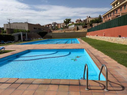 a large swimming pool with blue water at Ulldemolins Niuet in Ulldemolins