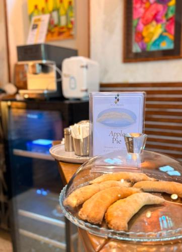 a plate of pastries on a counter in a restaurant at Arts Hotel Tbilisi in Tbilisi City