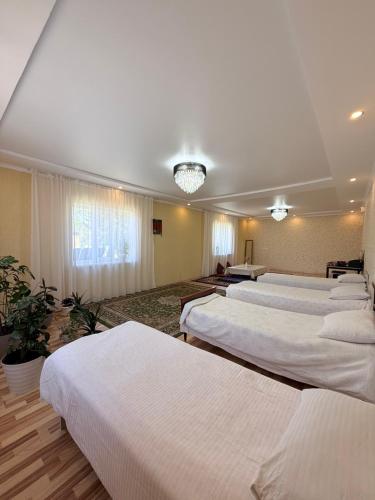 a room with a bunch of beds in it at Dan guest house in Pokrovka