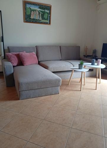 a living room with a couch and two tables at Zarakas home in Monemvasia