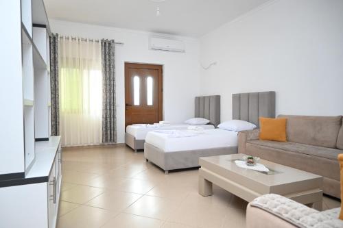a living room with two beds and a couch at Villa Nertili 1 in (( Kalive Gjoka ))