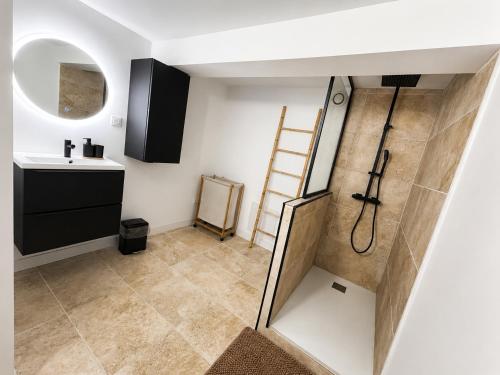 a small bathroom with a sink and a shower at Appartement neuf & élégant Centre Dunkerque rue de la porte d'eau in Dunkerque