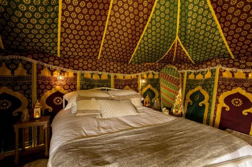 a bedroom with a bed in a room with wallpaper at Westerlands Farm in Graffham