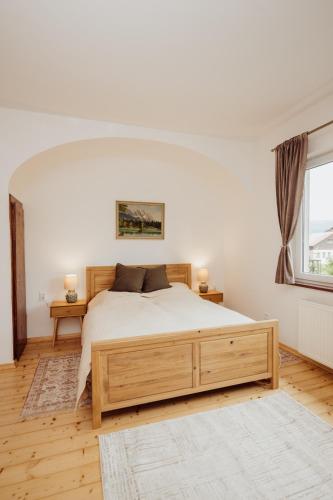 a bedroom with a large bed and a window at Willa Berg Cieplice in Jelenia Góra