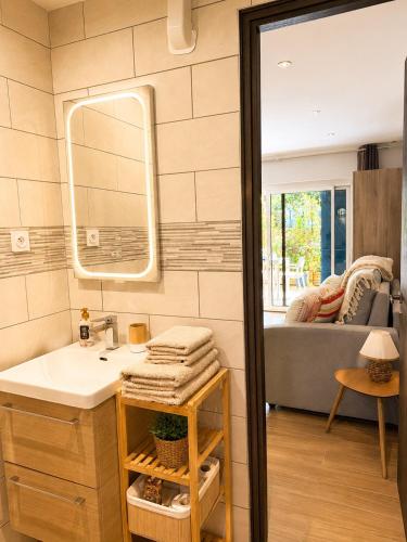 a bathroom with a sink and a mirror at Studio cosy a 500m de la plage in Fréjus