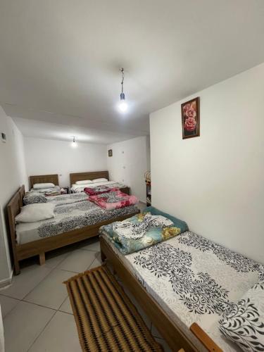 a room with two beds in a room at Hostel Sherifaj in Valbonë