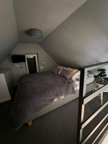 a bedroom with a bed in a attic at Domki za Wyspą in Chmielów