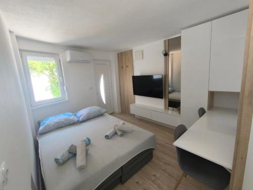 a bedroom with a bed with two towels on it at El Higo Apartments in Mostar