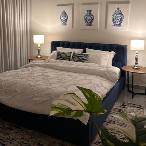 a bedroom with a bed with blue vases on the wall at وحده خاصة بمدخل مباشر s1 in Al Kharj